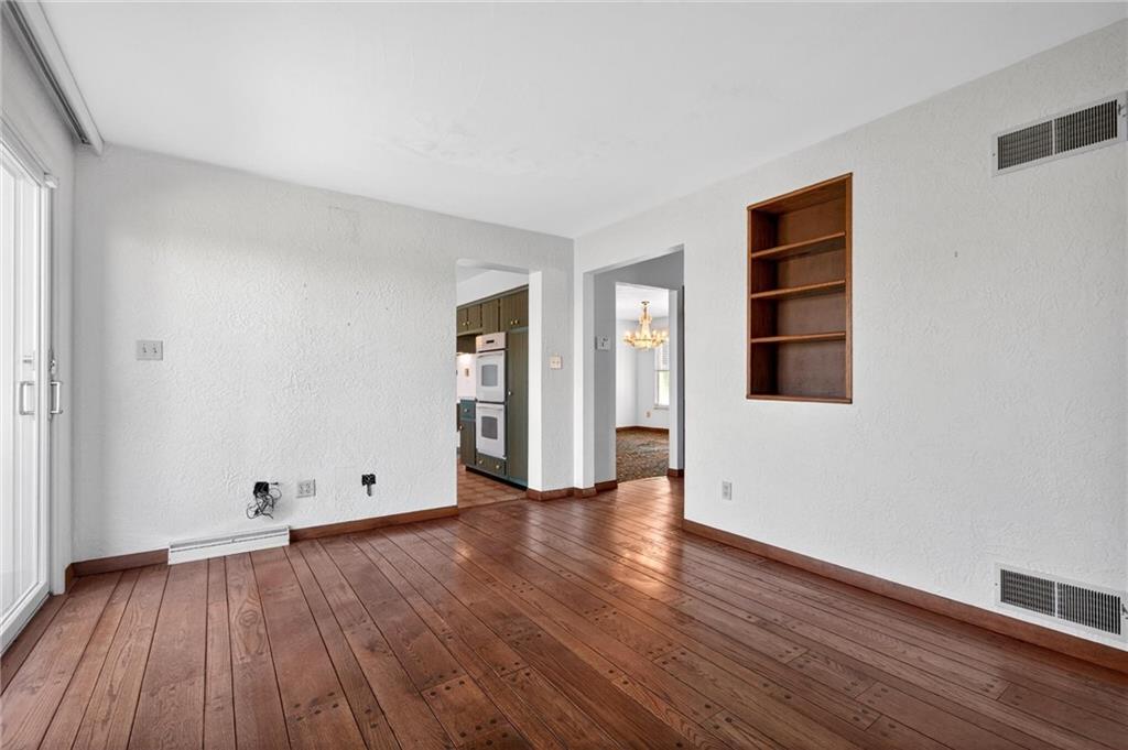 110 Spring Drive Apollo, PA 15613 - Photo 6 of 50 an empty room with wooden floor and windows