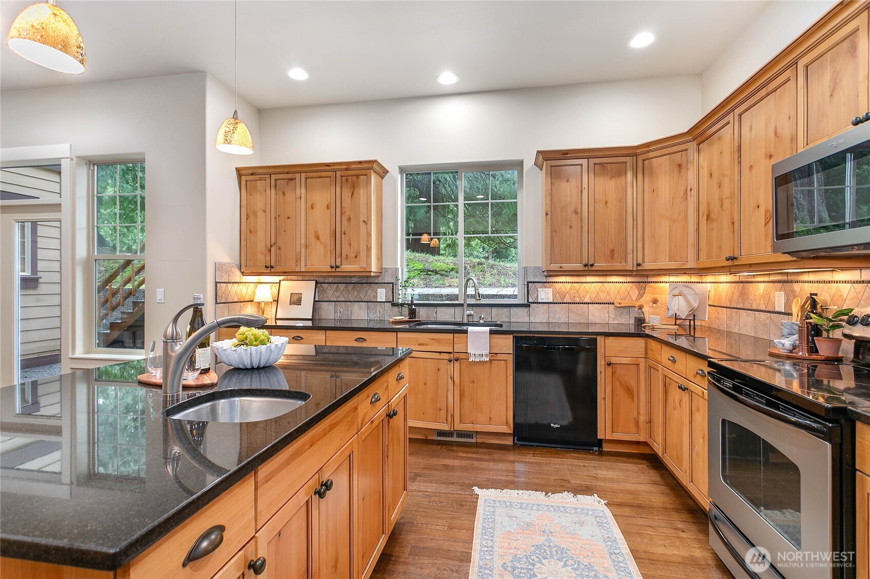 61 Windward Drive Bellingham, WA 98229 - Photo 12 of 36 a kitchen with stainless steel appliances granite countertop a sink stove and cabinets