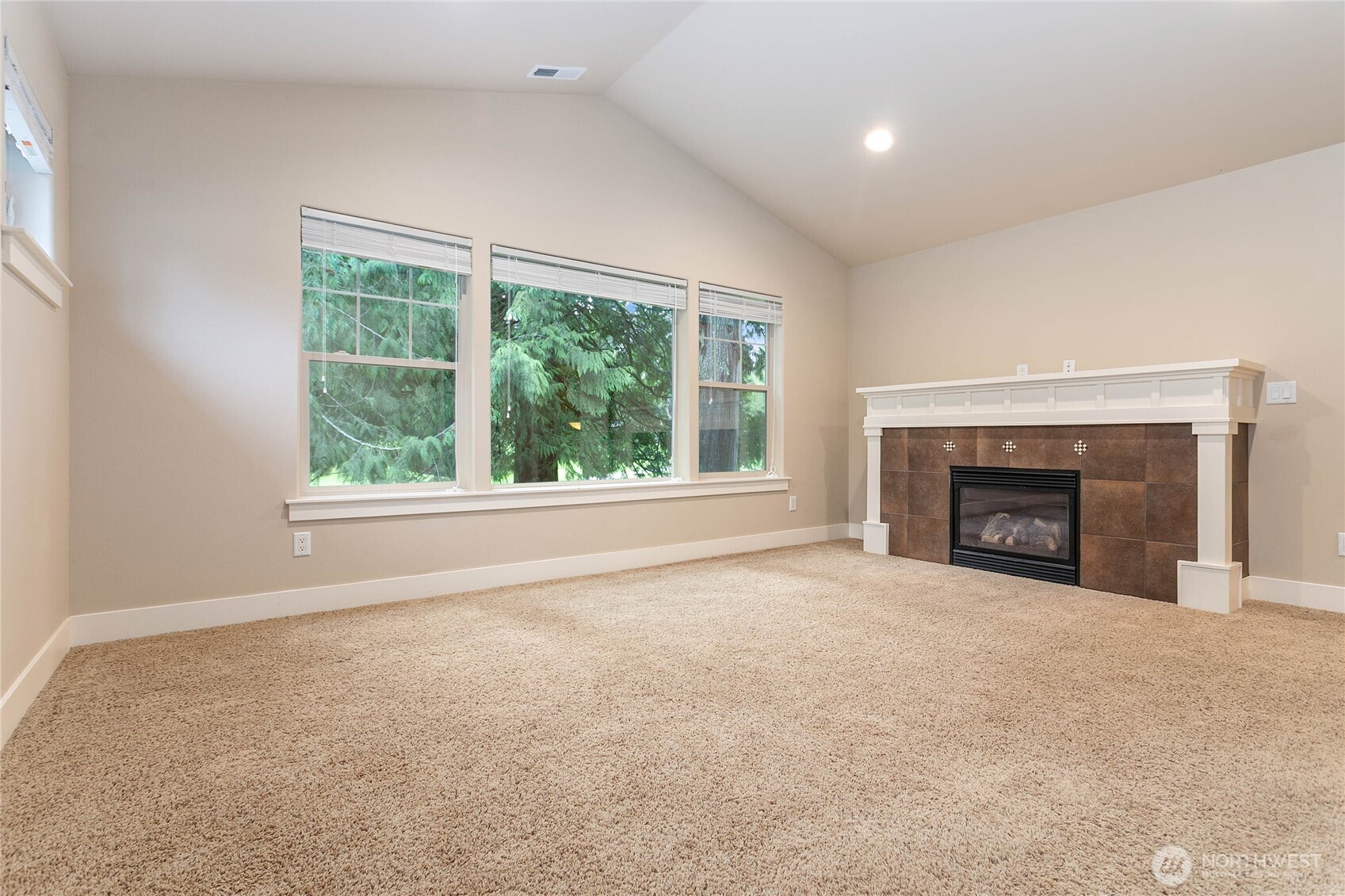 61 Windward Drive Bellingham, WA 98229 - Photo 23 of 36 an empty room with windows and a fireplace