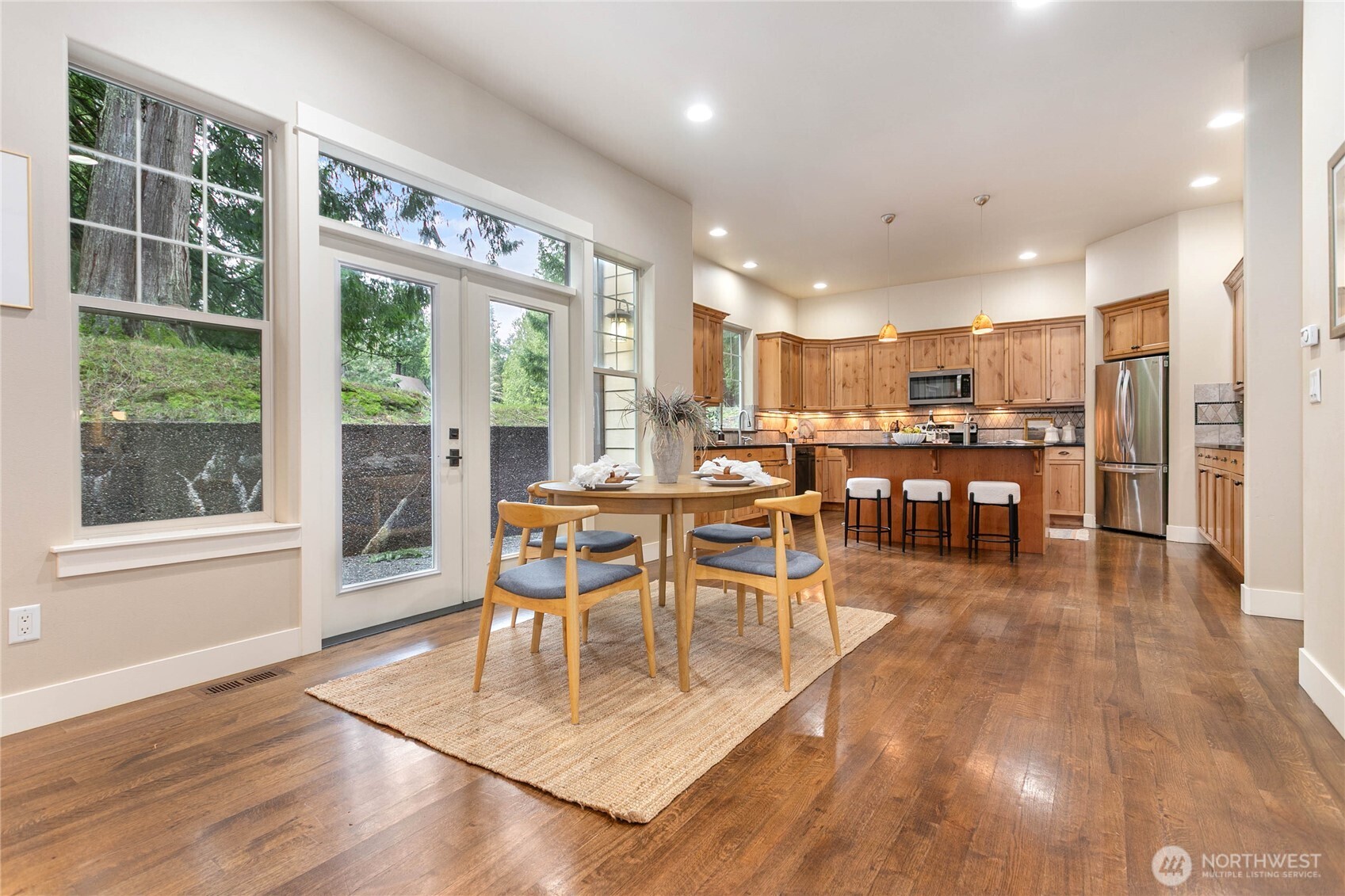 61 Windward Drive Bellingham, WA 98229 - Photo 8 of 36 a dining room with stainless steel appliances granite countertop a table chairs and a view of kitchen