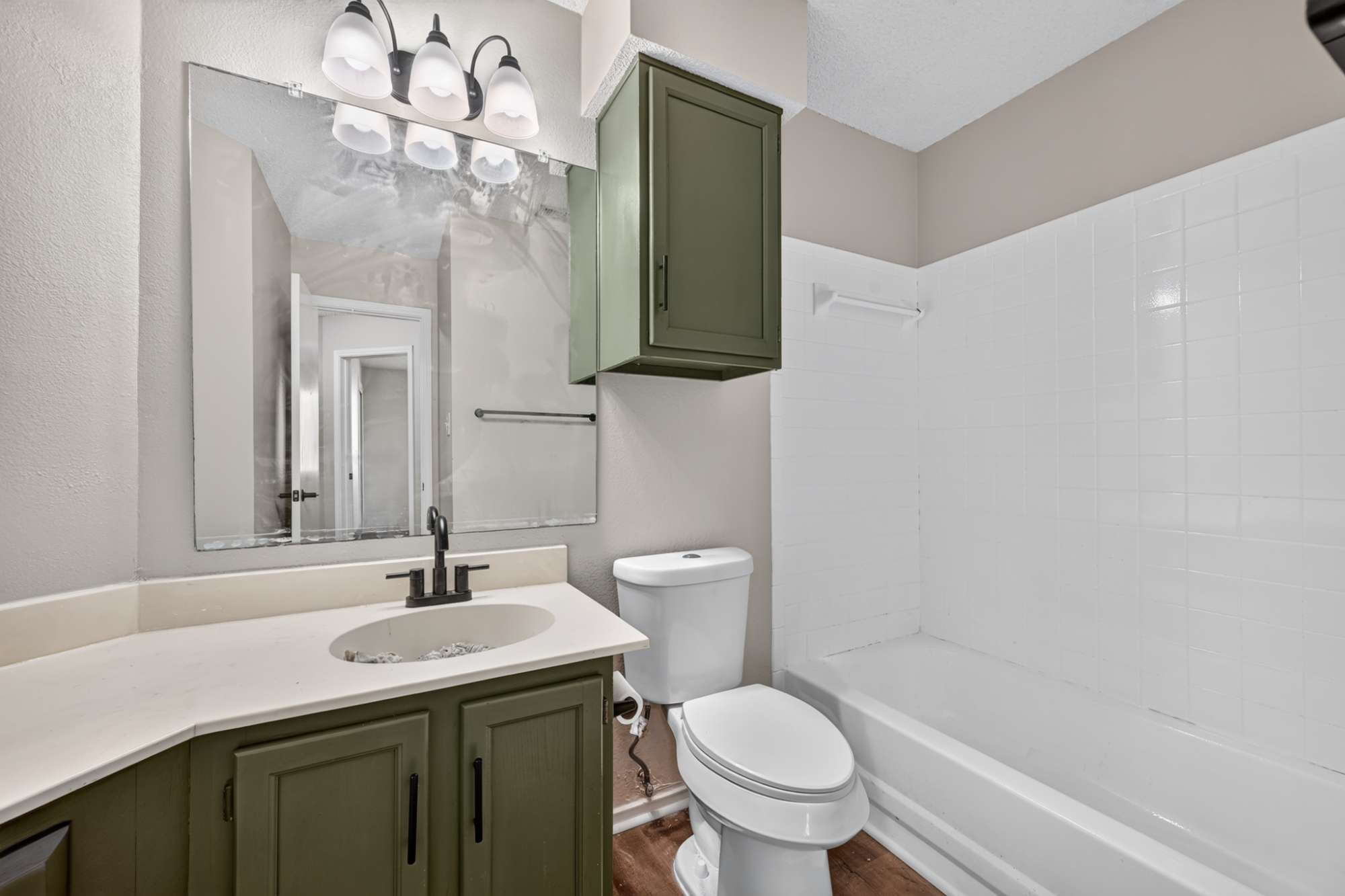 904 Nelson Ranch Road Cedar Park, TX 78613 - Photo 17 of 21 Tiled bathing alcove sits adjacent to a modern vanity with integrated sink basin.