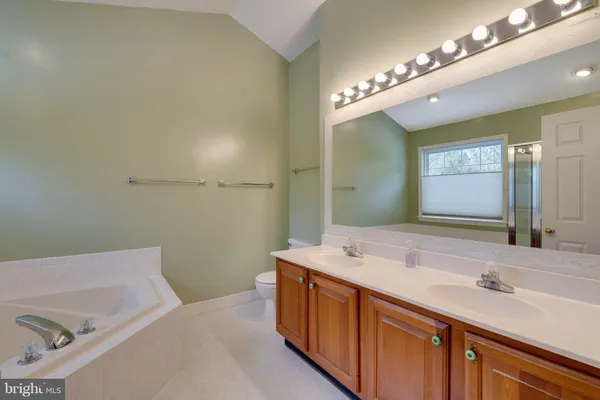 a view of washer and dryer with kitchen in the background