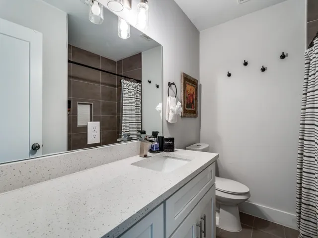 a bathroom with a sink toilet and mirror