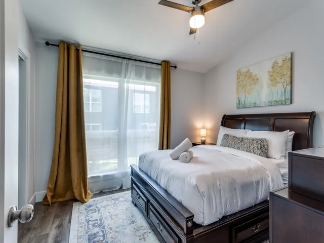 a bedroom with a bed and a window