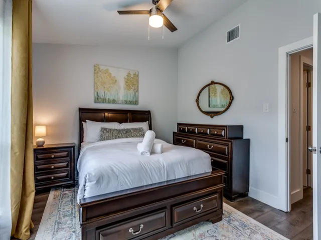 a bedroom with a bed and a chandelier