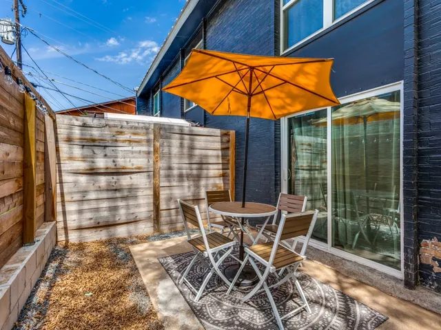 a patio with a table and chairs