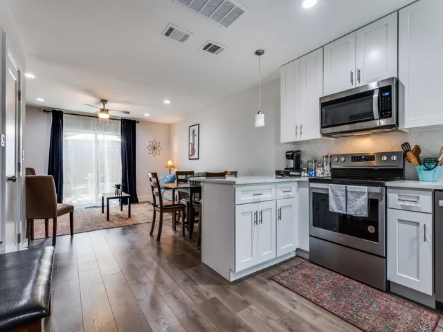 a kitchen with a sink cabinets and stainless steel appliances