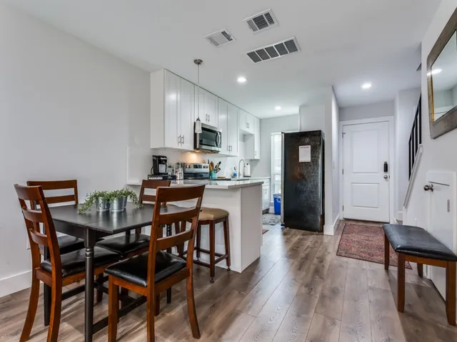 a view of a dining room with furniture and wooden floor