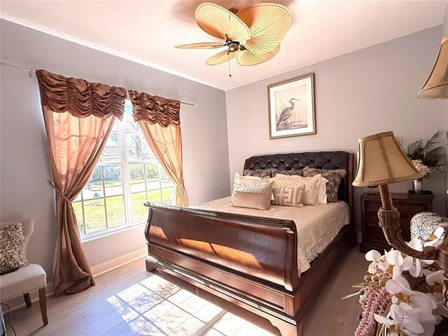 a bedroom with a bed and wooden floor