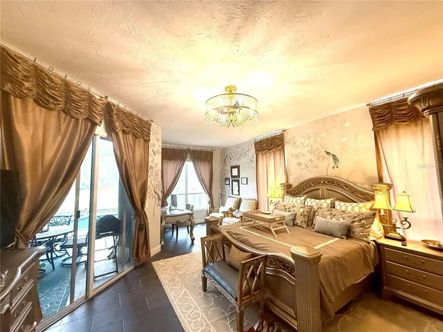 a bedroom with a bed and a chandelier