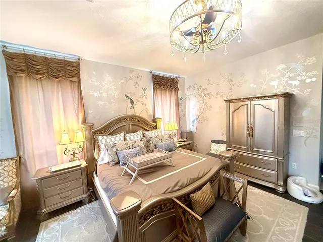 a bedroom with a bed and a chandelier
