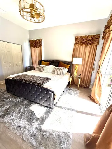 a large bed sitting in a bedroom next to a window