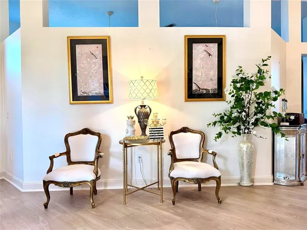 a living room with furniture and a potted plant