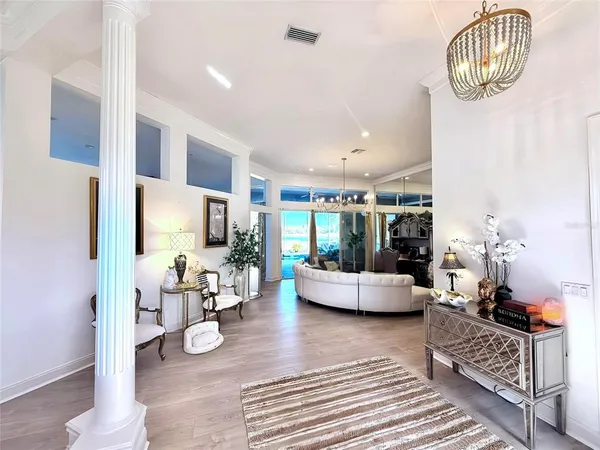 a living room with furniture and a chandelier