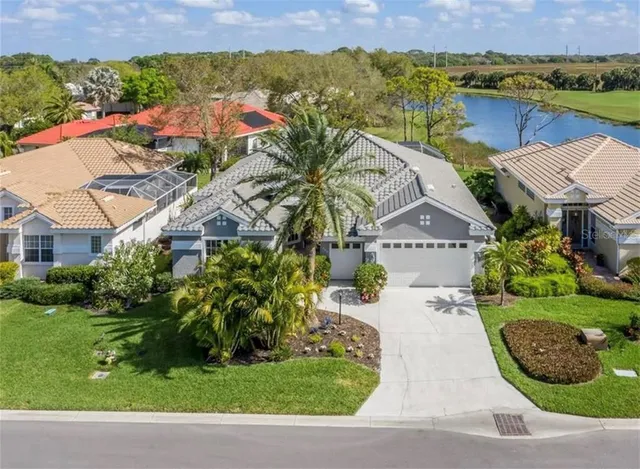 an aerial view of residential houses with outdoor space and river