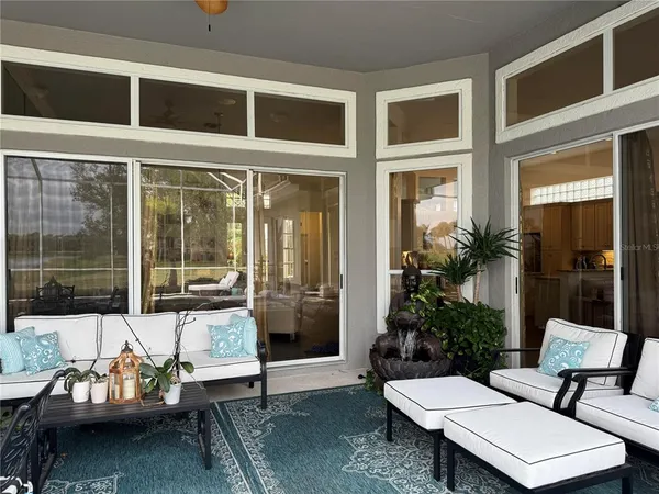 a view of a patio with couple of chairs and a couch