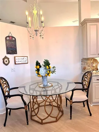 a view of a dining room with furniture and chandelier