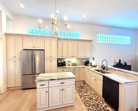 a kitchen with a sink window and refrigerator