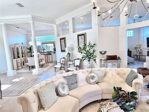 a living room with furniture and a large mirror