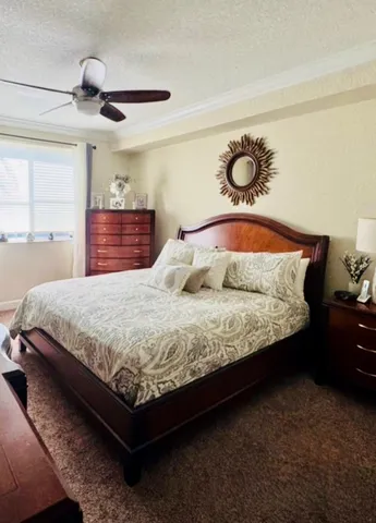 an empty room with windows and ceiling fan