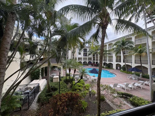 a view of yard with swimming pool and seating area
