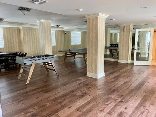 a living room with furniture wooden floor and a large window