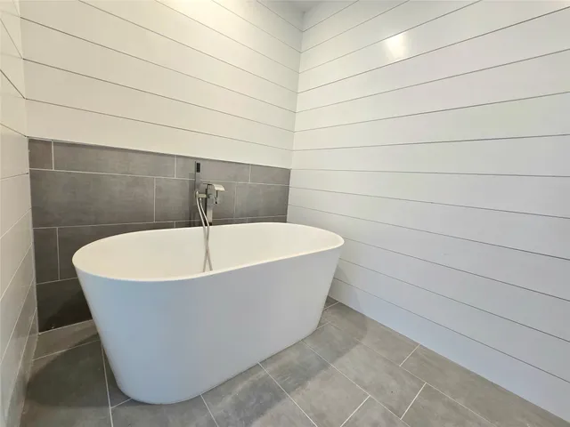 a white tub sitting in a bathroom