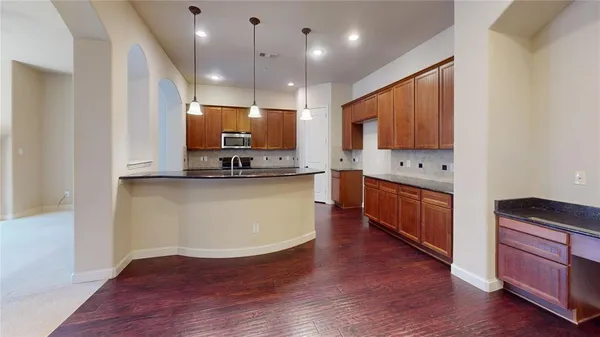 a kitchen with stainless steel appliances granite countertop a sink a stove and a refrigerator