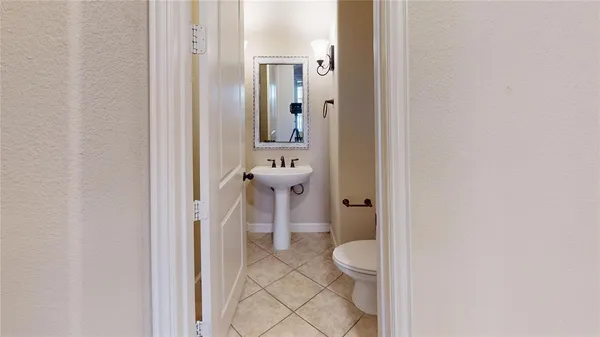 a bathroom with a granite countertop toilet and a sink