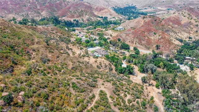 a view of a houses with a lush green hillside