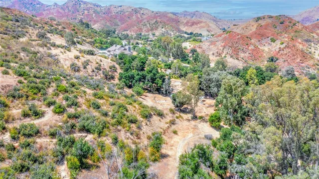 an aerial view of a house a yard and green space