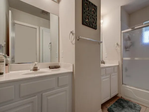 a bathroom with a double vanity sink and mirror