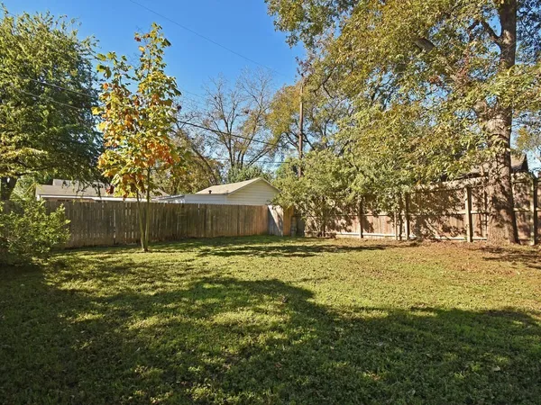 a backyard of a house with large trees