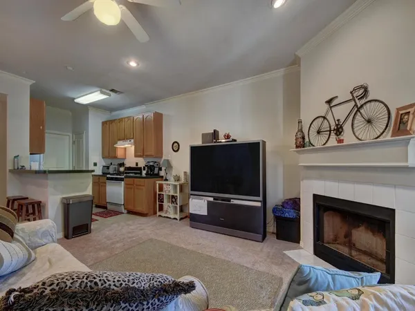 a living room with furniture a fireplace and a flat screen tv
