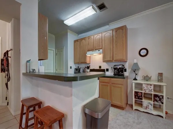 a kitchen with a sink cabinets and window
