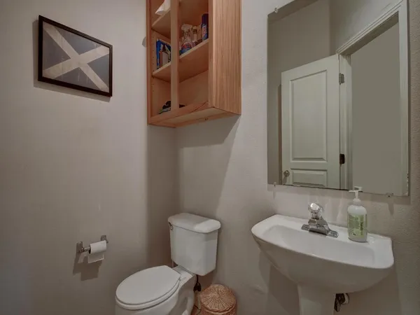 a bathroom with a toilet sink and mirror