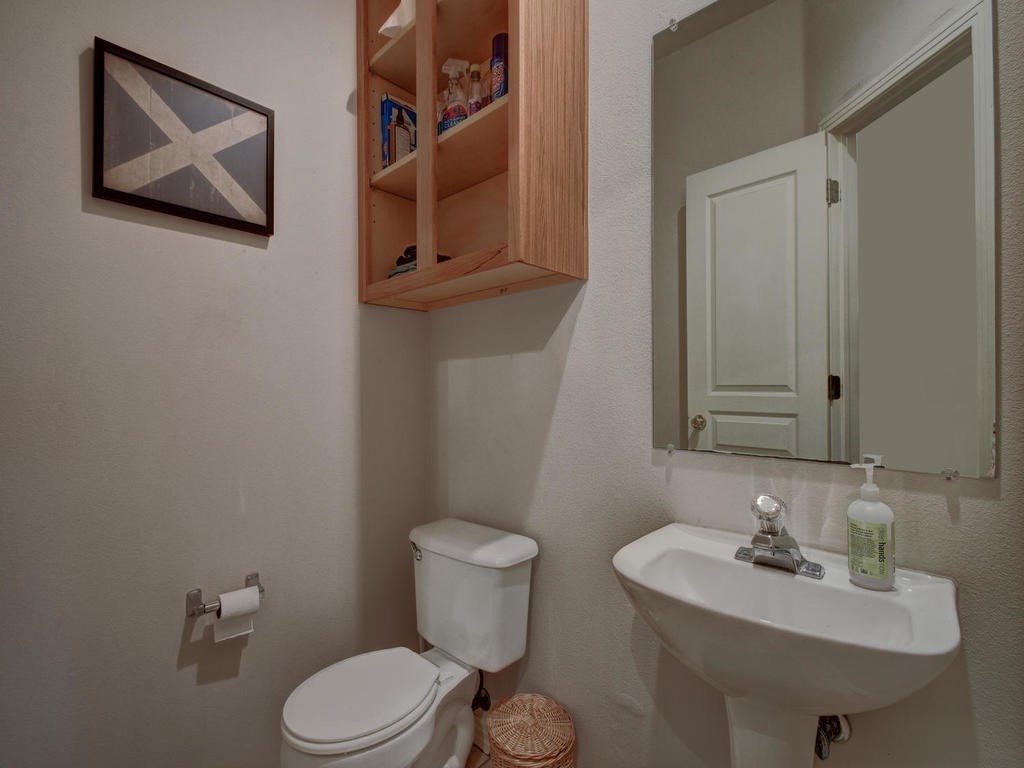 609 East 49th Street, Unit B Austin, TX 78751 - Photo 9 of 19 a bathroom with a toilet sink and mirror