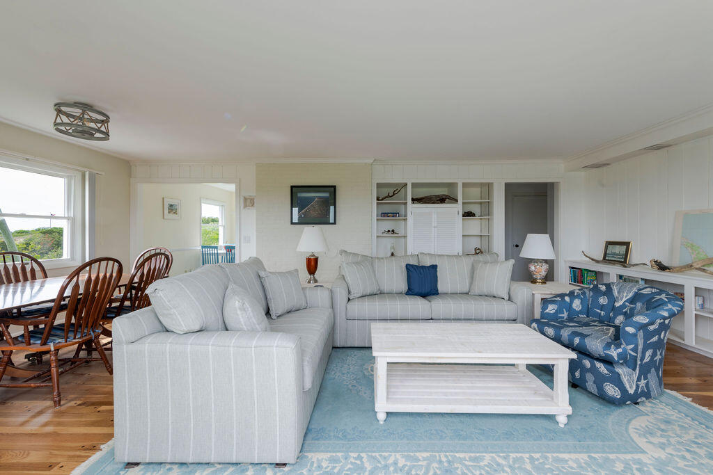 2 Ryder Hollow Road Truro, MA 02666 - Photo 11 of 33 a living room with furniture a table and wooden floor
