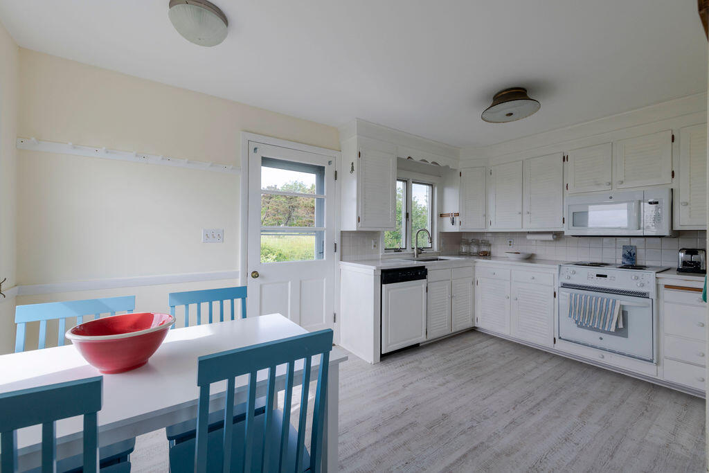 2 Ryder Hollow Road Truro, MA 02666 - Photo 14 of 33 a kitchen with cabinets appliances and a dining table