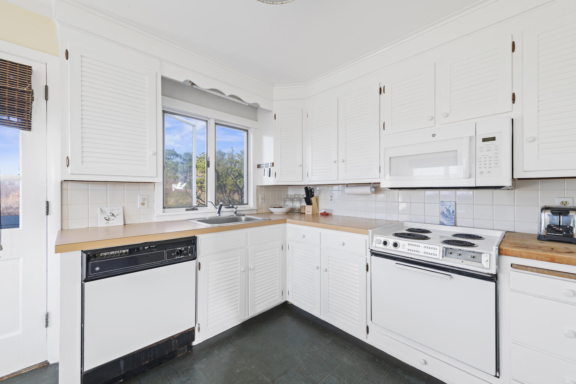 2 Ryder Hollow Road Truro, MA 02666 - Photo 16 of 33 a kitchen with cabinets appliances a sink and a window