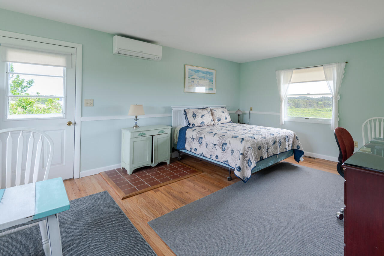 2 Ryder Hollow Road Truro, MA 02666 - Photo 17 of 33 a bedroom with a bed and a furniture next to a window