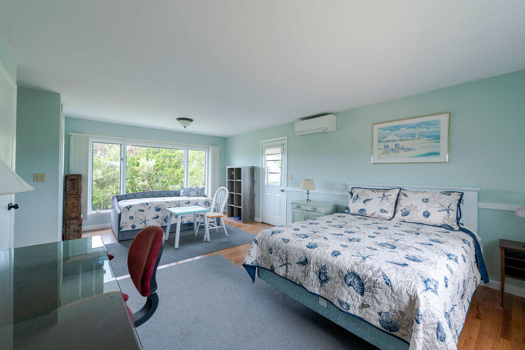 2 Ryder Hollow Road Truro, MA 02666 - Photo 18 of 33 a bedroom with a bed and a large window