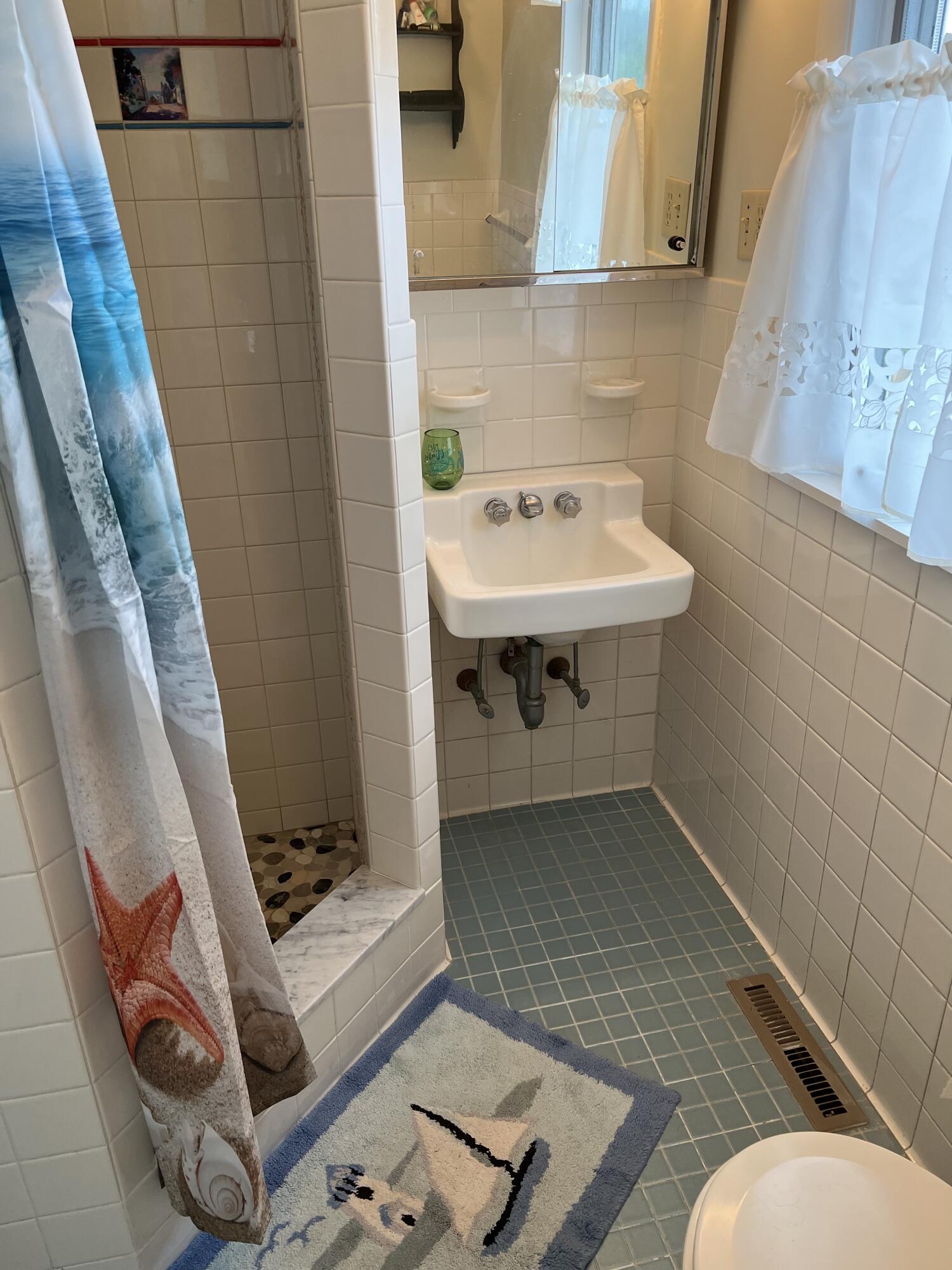2 Ryder Hollow Road Truro, MA 02666 - Photo 21 of 33 a bathroom with a sink and a mirror