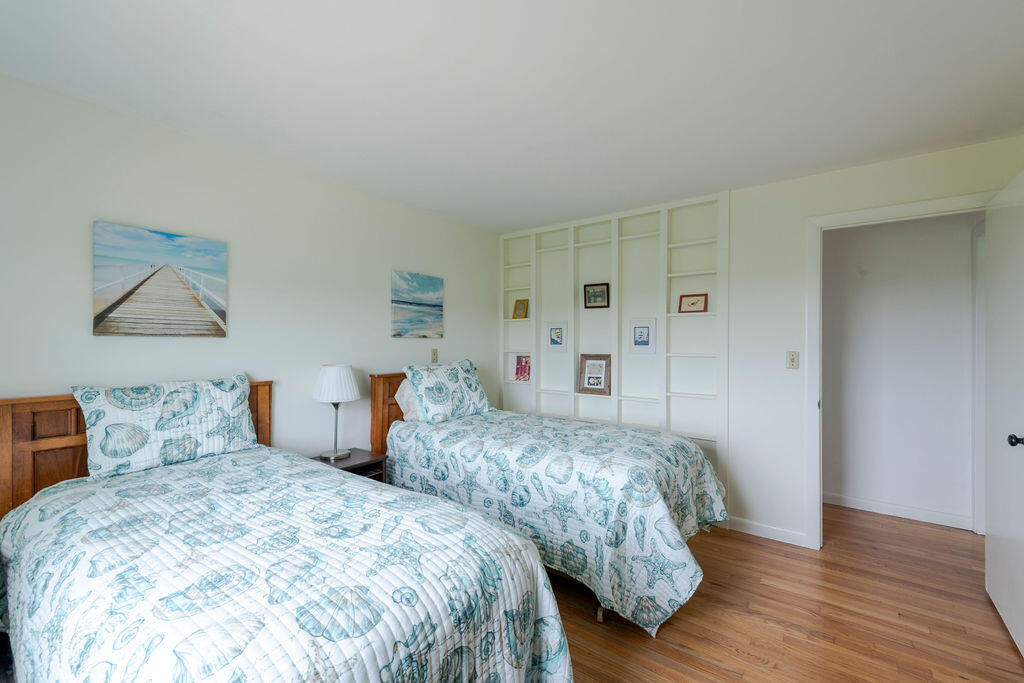2 Ryder Hollow Road Truro, MA 02666 - Photo 24 of 33 a bedroom with two beds and painting on the wall