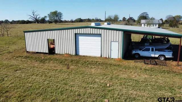 a view of a house with a patio and a slide