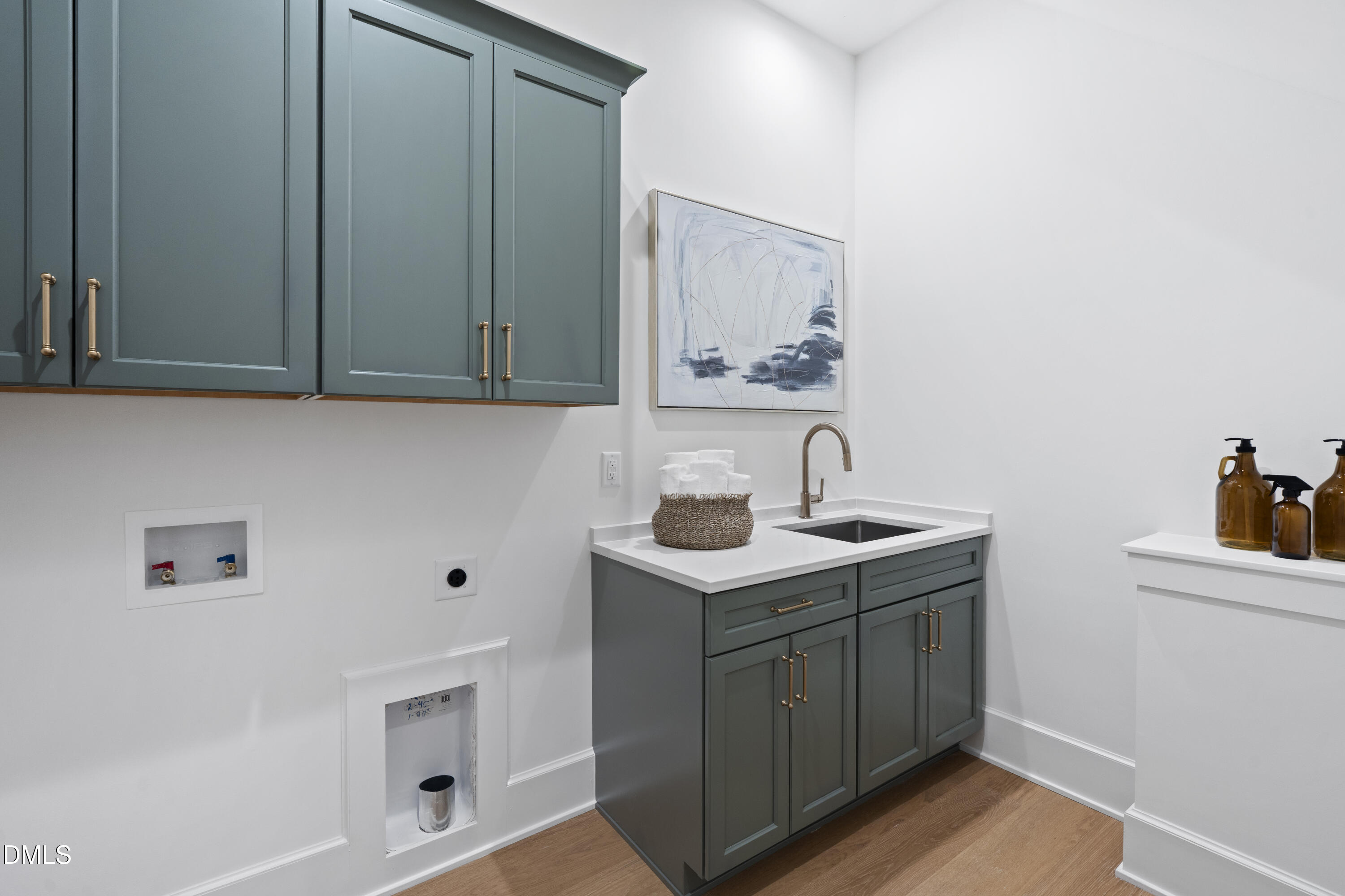 709 Mills Street Raleigh, NC 27608 - Photo 11 of 37 a view of cabinets with sink and wooden floor