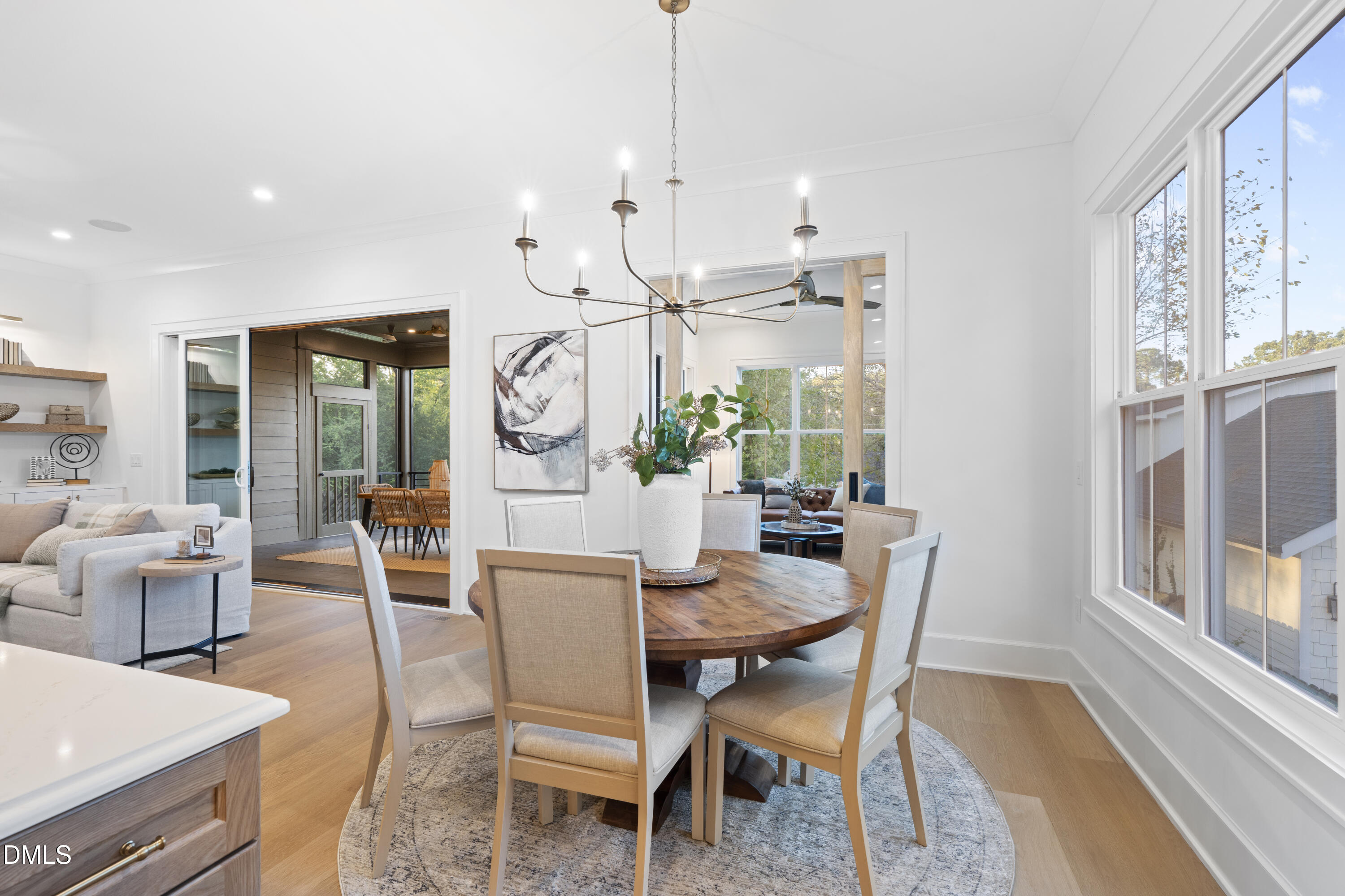 709 Mills Street Raleigh, NC 27608 - Photo 19 of 37 a dining room with furniture a chandelier and wooden floor
