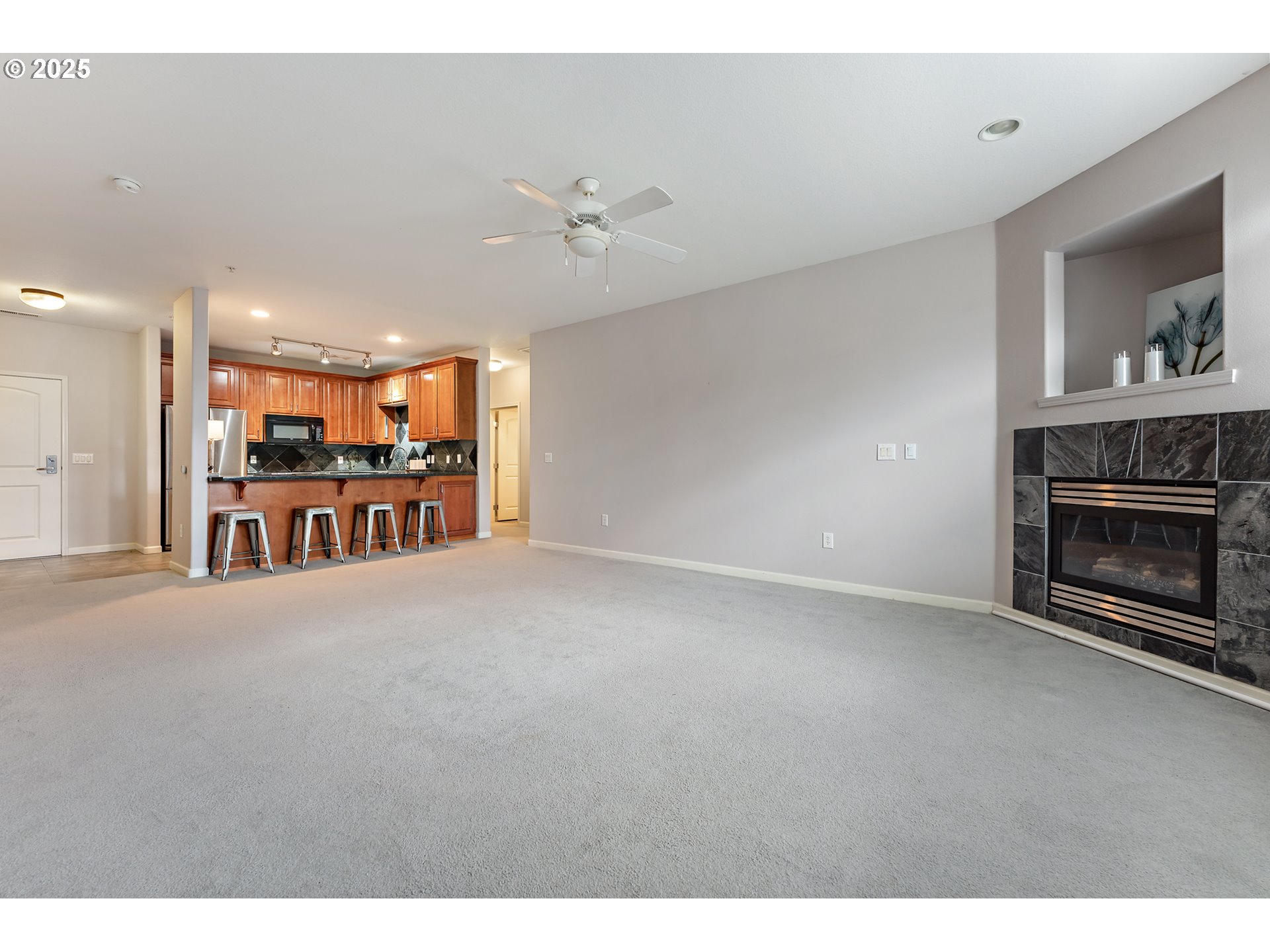 20508 Southwest Roy Rogers Road, Unit 328 Sherwood, OR 97140 - Photo 13 of 48 a view of a livingroom with furniture a fireplace a ceiling fan and window