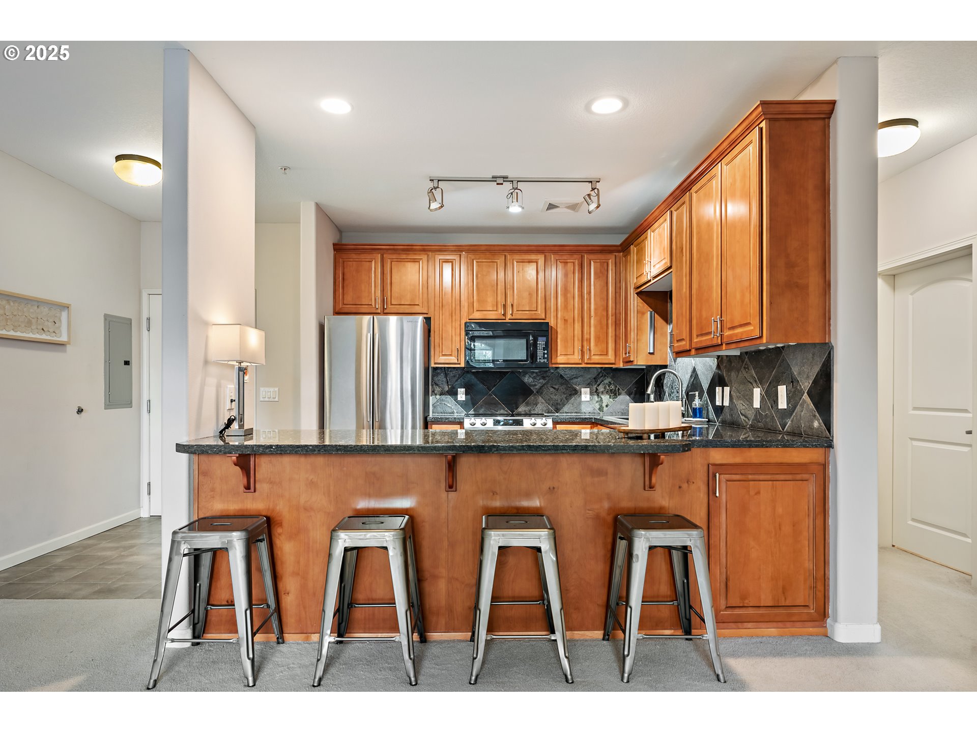 20508 Southwest Roy Rogers Road, Unit 328 Sherwood, OR 97140 - Photo 20 of 48 a kitchen with white cabinets and chair