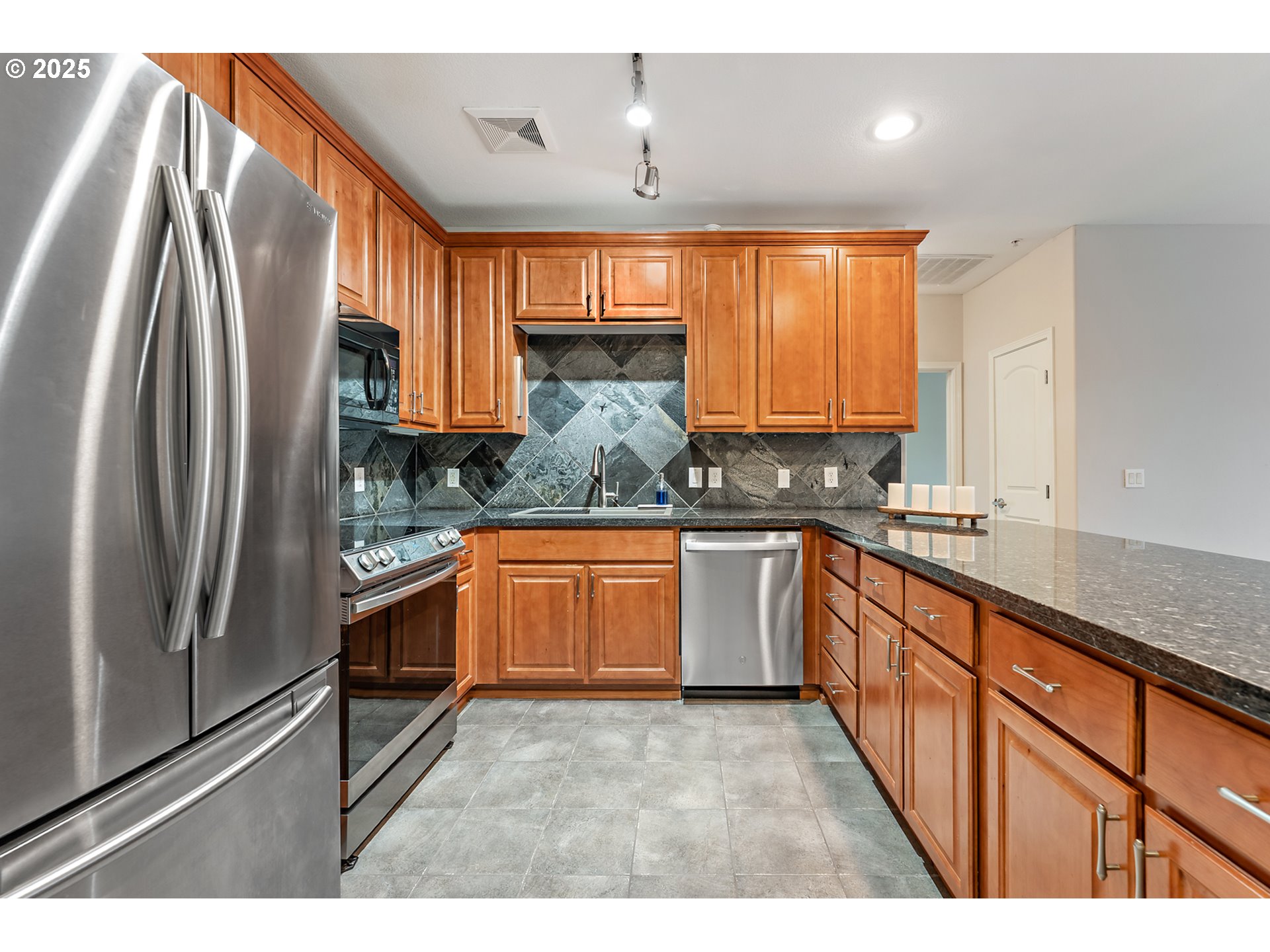 20508 Southwest Roy Rogers Road, Unit 328 Sherwood, OR 97140 - Photo 22 of 48 a kitchen with stainless steel appliances granite countertop a refrigerator a sink dishwasher a stove and white countertops with wooden floor